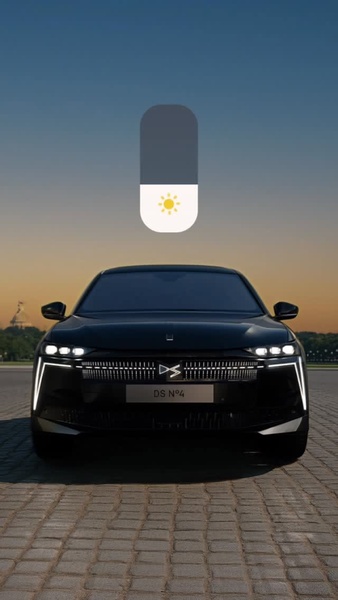 This ad features a luxury car centered in a minimalist environment with a digital light slider overlay, indicating the vehicle's unique illumination features.