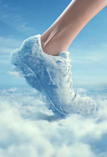 A surreal creative showcasing a running shoe seamlessly integrated into a cloud formation, symbolizing extreme comfort and lightweight performance.
