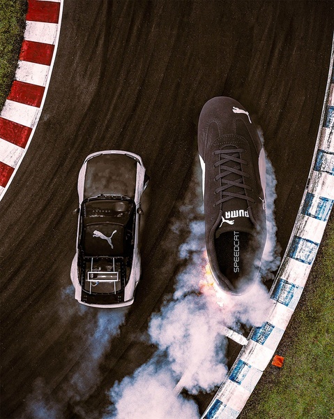 An aerial view showing a shoe drifting like a race car on a track, creating tire-like smoke trails to emphasize agility and speed.