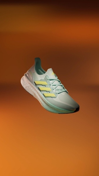A high-quality 9:16 studio shot of a light green and yellow running shoe suspended against a warm, gradient background.