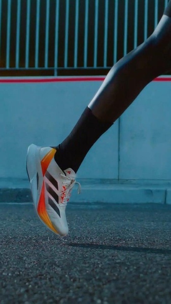 A close-up, high-speed capture of a runner's stride focusing on the technical features and color profile of the high-performance shoe.