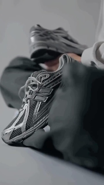 A close-up, desaturated product shot of a high-performance running shoe, focusing on texture and design details to build brand desire.