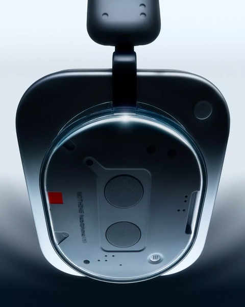 A high-contrast, overhead studio shot of wireless headphones emphasizing build quality and sleek industrial design through dramatic lighting.