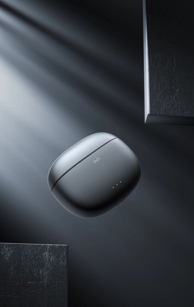 A high-end, floating product photography shot of wireless earbuds in a dark, atmospheric studio setting with cinematic lighting.