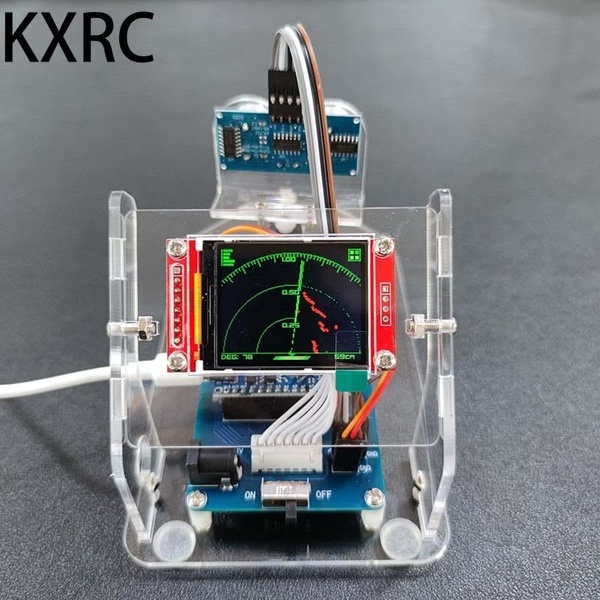 A close-up shot of a miniature radar sensor prototype mounted in a transparent acrylic stand, displaying a real-time sweep on a small LCD screen.
