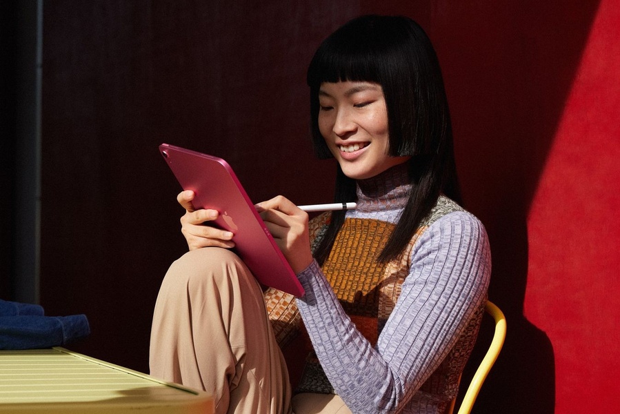 A vibrant, minimalist hero shot showing a user interacting with a tablet in a high-contrast environment to emphasize lifestyle integration.