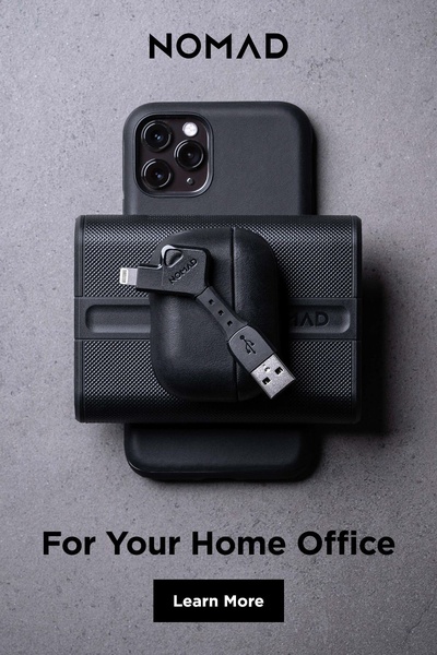 A top-down, centered composition showing a phone, wireless charger, and cable, emphasizing product organization for a clean workspace.