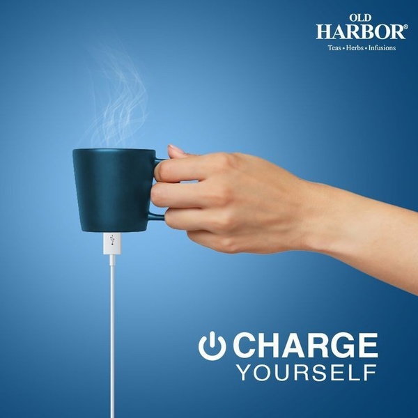 A minimalist, high-contrast creative using a tea mug as a visual metaphor for charging a battery to represent energy and refreshment.