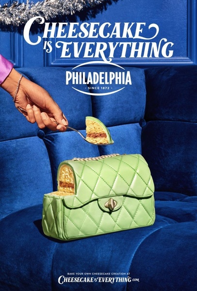 A surreal creative depicting a slice of cheesecake being served from a quilted handbag, set against a vibrant blue studio background.