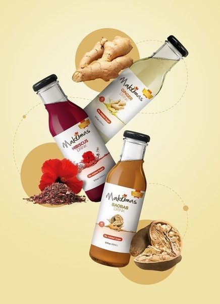 A clean, high-contrast creative featuring three glass bottles of natural drinks floating amidst their raw ingredients against a warm, soft-toned background.