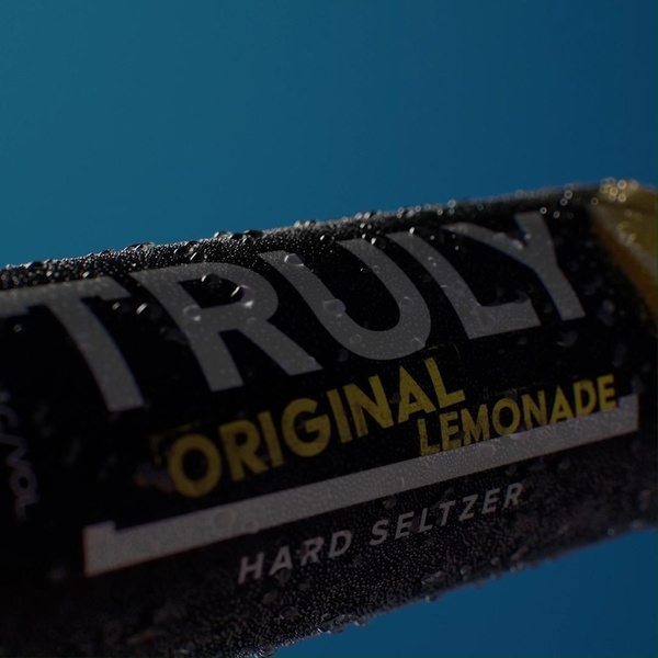 A close-up, high-detail macro shot of a hard seltzer can featuring water droplets and sharp product labeling.