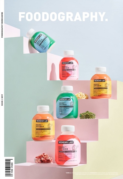 A clean, symmetrical product photography shot featuring various flavors of nutritional shake bottles arranged on a pastel-colored staircase.