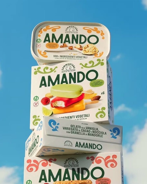 A vertical stack of vegetable-based ice cream packaging set against a bright blue sky, emphasizing product variety and natural ingredients.