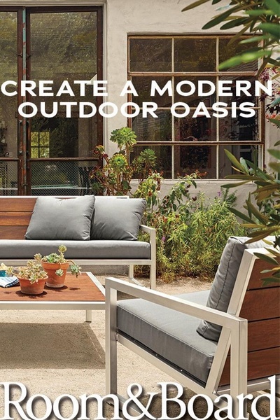 A clean, aspirational shot of outdoor lounge furniture set against a rustic windowed building, featuring clear, bold typography.