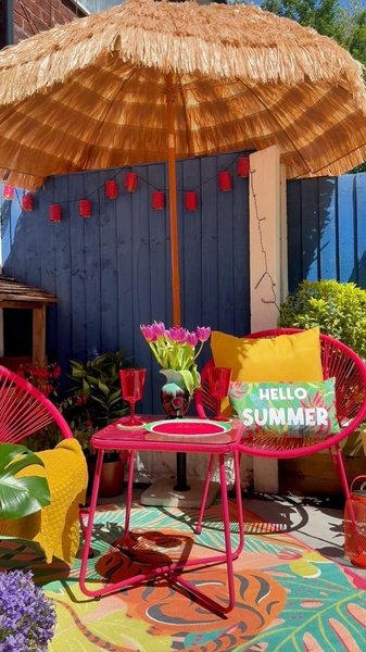 A 9:16 vertical social ad showcasing a bright pink patio furniture set under a straw umbrella, styled for a summer aesthetic.