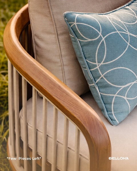 A close-up aesthetic shot of an outdoor lounge chair featuring warm wood tones and a blue patterned cushion, using scarcity messaging to drive urgency.
