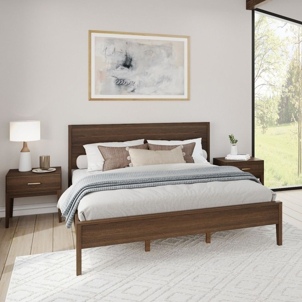A clean, lifestyle-focused ad creative featuring a wooden bed frame in a brightly lit, modern bedroom setting.