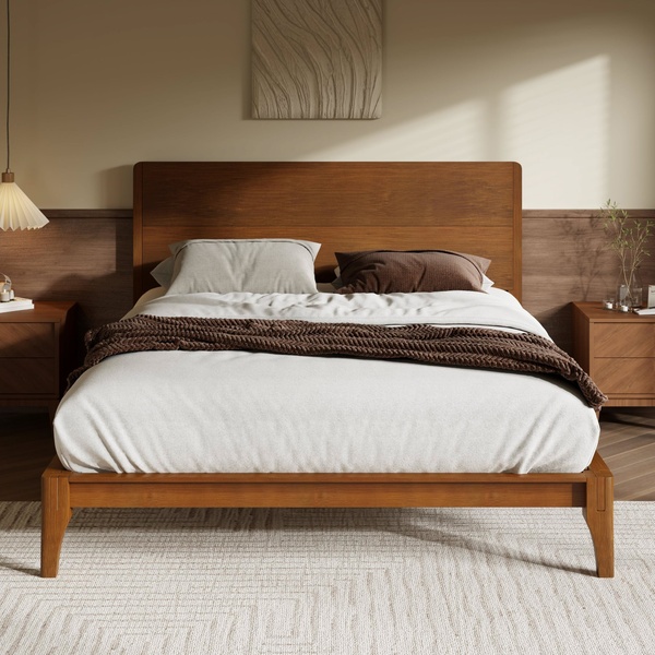 A clean, high-end studio capture of a modern wooden bed frame styled with neutral textures and soft, natural morning light.