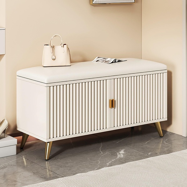A high-quality 1:1 image featuring a cream-colored ribbed storage bench styled in a neutral, modern home entryway.