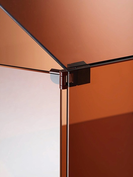 A close-up, high-detail shot of a glass display case focusing on the precision of the hinges and the amber-toned transparency of the material.