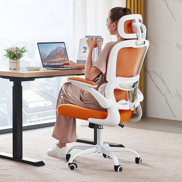 A high-quality lifestyle shot of a woman working at a home office setup, highlighting the ergonomic design of the orange office chair.