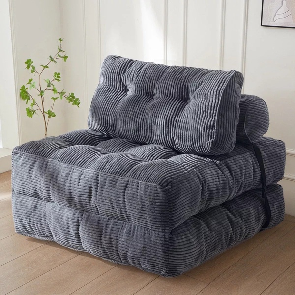 A high-quality, studio-lit photograph of a modular gray corduroy floor sofa, showcasing its texture and simple, modern aesthetic.