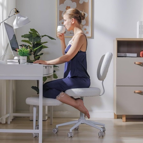 This ad creative features a woman in a relaxed setting, sitting comfortably on a modern, textured home office desk chair while working.