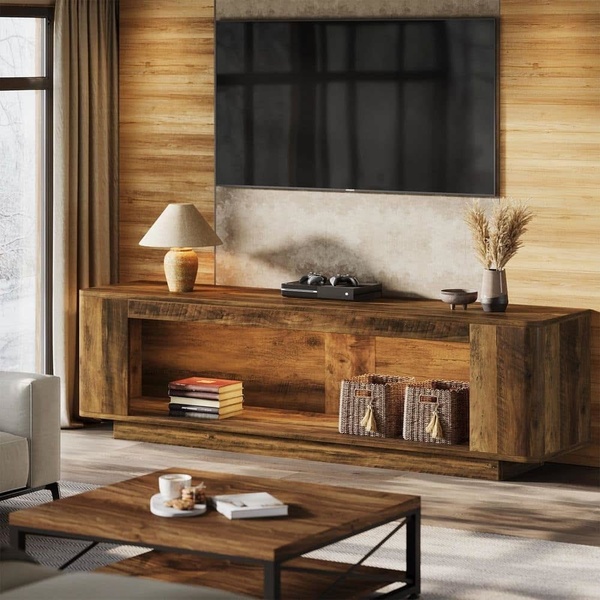 A high-quality lifestyle shot featuring a minimalist wood media console in a warm, modern living room setting.
