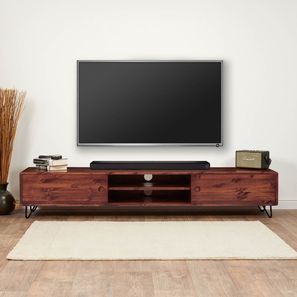 A high-quality, static image of a wooden media console positioned directly under a wall-mounted television, presented in a clean, brightly lit setting.
