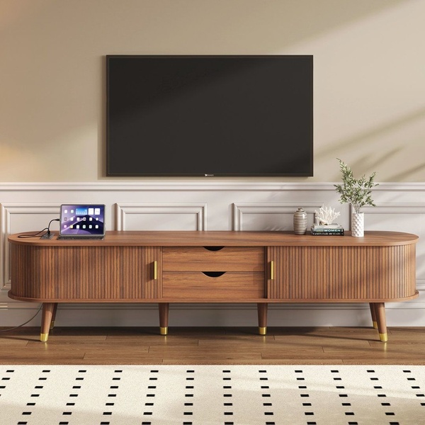 A high-fidelity, centered product hero shot of a wooden media console in a neutral-toned living room setting.