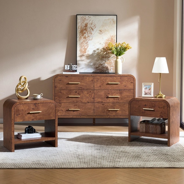 A high-end, lifestyle-focused product hero shot of a burl wood nightstand and matching dresser in a warm, minimalist bedroom setting.