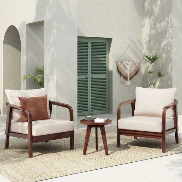 A high-quality lifestyle shot of two outdoor lounge chairs and a small table set against a modern, textured architectural backdrop.