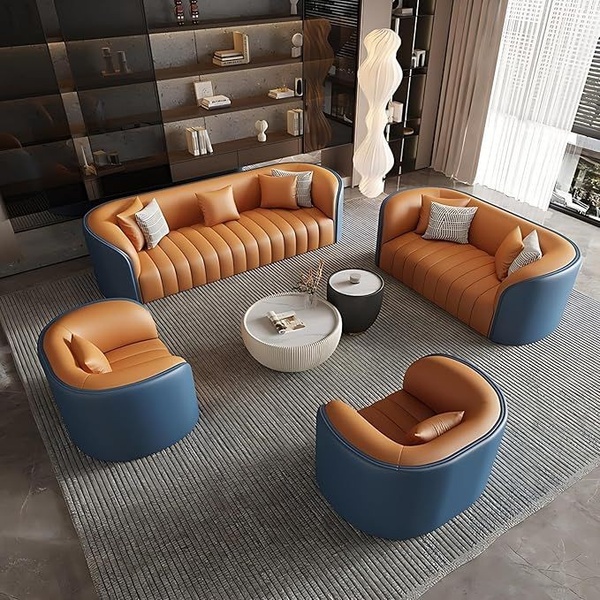 A high-angle studio shot of a modern, curved sofa set in tan leather and blue accents, arranged around a circular coffee table in a minimalist living room.
