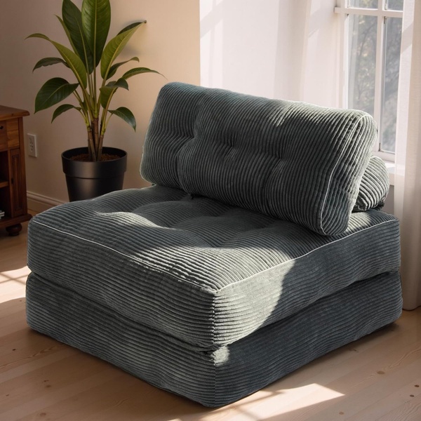A high-quality, studio-lit image of a green corduroy floor cushion positioned near a window, emphasizing texture and home comfort.