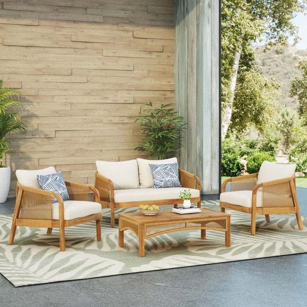 A high-quality 1:1 lifestyle shot of an outdoor lounge furniture set staged on a patio with natural light.
