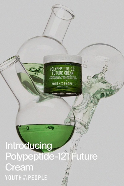 A high-contrast product hero shot featuring the moisturizer jar surrounded by glass laboratory equipment and green liquid to emphasize clinical effectiveness.