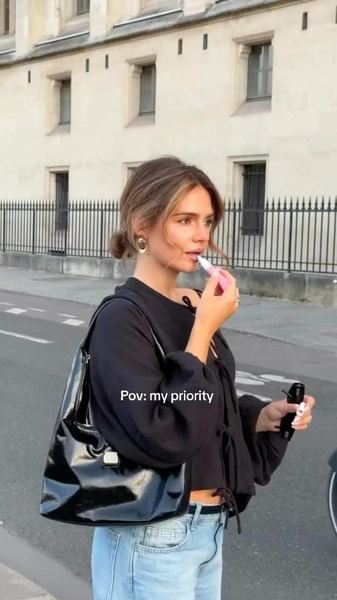 A casual, street-style video creative focusing on the immediate priority of applying a lip care product in a relatable, authentic setting.