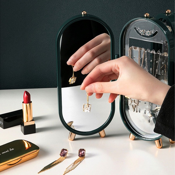 A refined, lifestyle-focused shot featuring a compact jewelry organizer with a hand interacting with a delicate piece, capturing a sense of luxury and order.