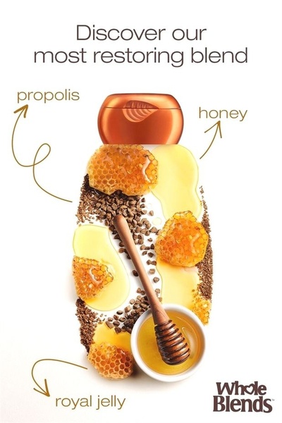 A clean, minimalist product ad for shampoo showcasing natural ingredients like honey, propolis, and royal jelly arranged around the bottle.