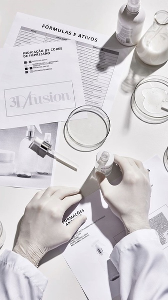 A top-down, laboratory-themed product shot featuring a gloved technician reviewing ingredient formulas and serum samples, signaling clinical authority.