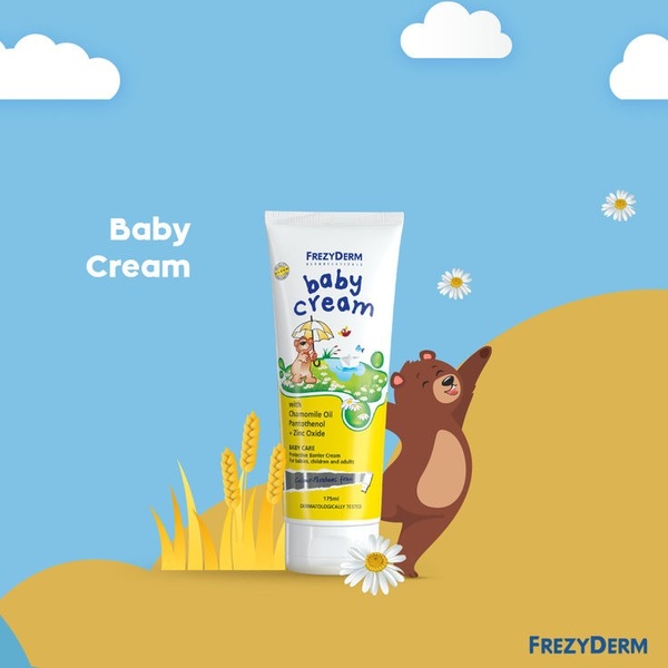 A 1:1 format product hero ad featuring a baby cream tube surrounded by cheerful bear and chamomile illustrations, set against a soft blue sky and gold landscape.