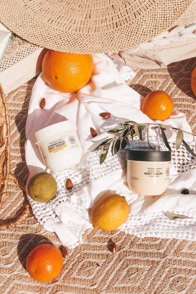 body yogurt, body moisturizer, body lotion, skincare cream, body cream, product demo, flat lay, calm, fresh, neutral, yellow, orange
