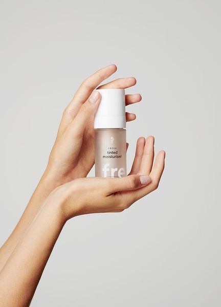 tinted moisturizer, face makeup, liquid foundation, skincare makeup, tinted cream, product demo, minimalist, lifestyle, calm, fresh, neutral