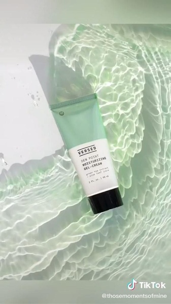 A high-end, minimalist product shot featuring a moisturizing gel-cream tube submerged in a clear, serene pool of water with soft light reflections.