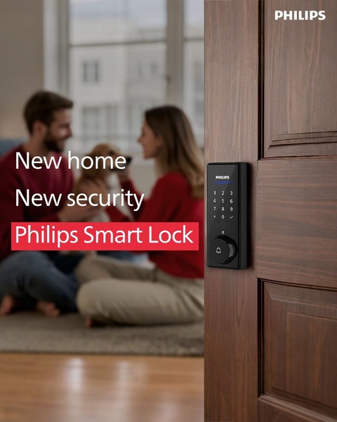 A warm, lifestyle-oriented ad featuring a couple and their pet in a new home setting with a close-up focus on a Philips smart lock.