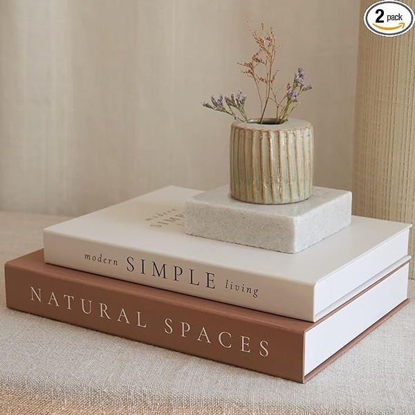 A refined product shot featuring a two-book set staged with a small ceramic vase to convey a modern and clean aesthetic.