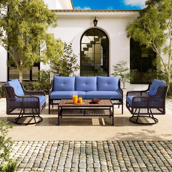 A high-quality 1:1 image displaying a modern patio furniture set arranged on a cobblestone courtyard, emphasizing a premium outdoor living experience.