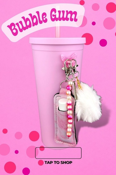 A vibrant, product-focused ad featuring a pink tumbler with a matching keychain, using bold typography and a playful, monochromatic color palette.