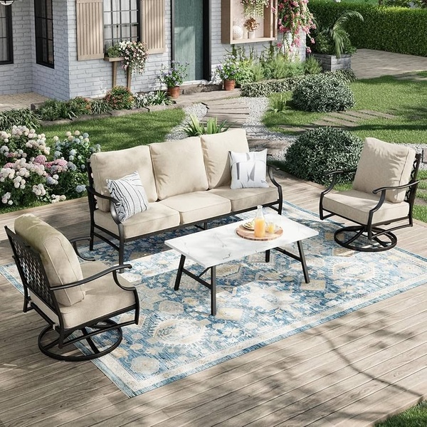 A high-quality lifestyle shot showing a complete outdoor seating group with a sofa, two swivel chairs, and a marble-top coffee table on a wooden deck.