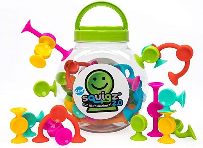 A bright, high-contrast studio shot showing a jar of colorful suction cup toys arranged to showcase the product variety and play potential.